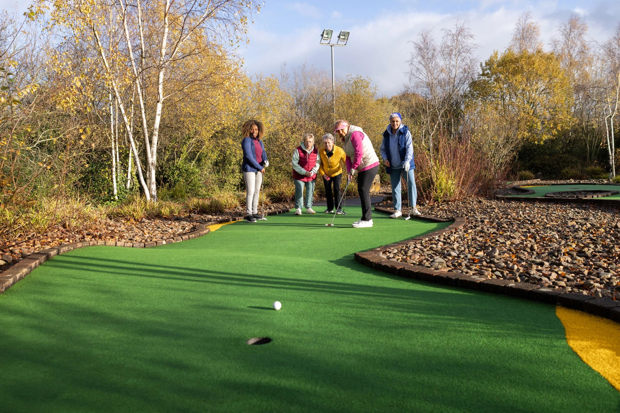 Group playing mini golf at a club