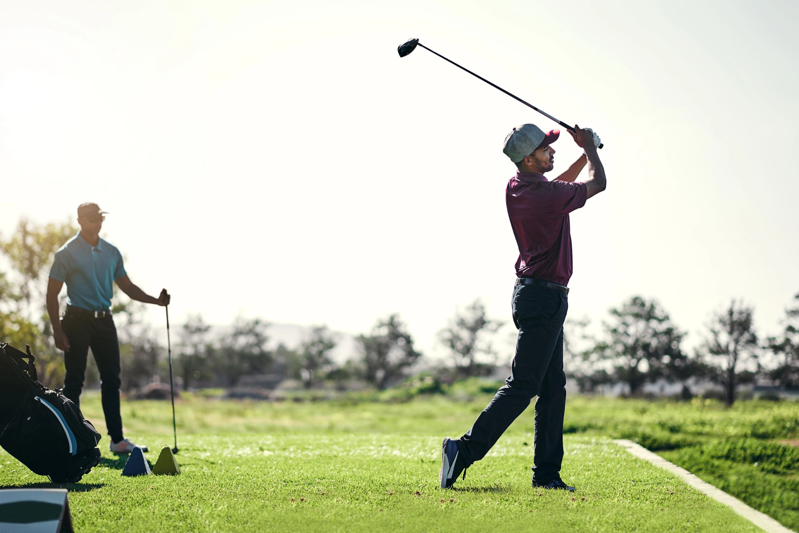 Golfer preparing to swing on a sunny course